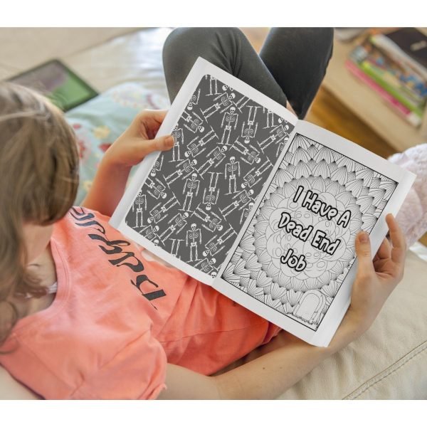 Woman looking at open pages of funny coloring book about morticians